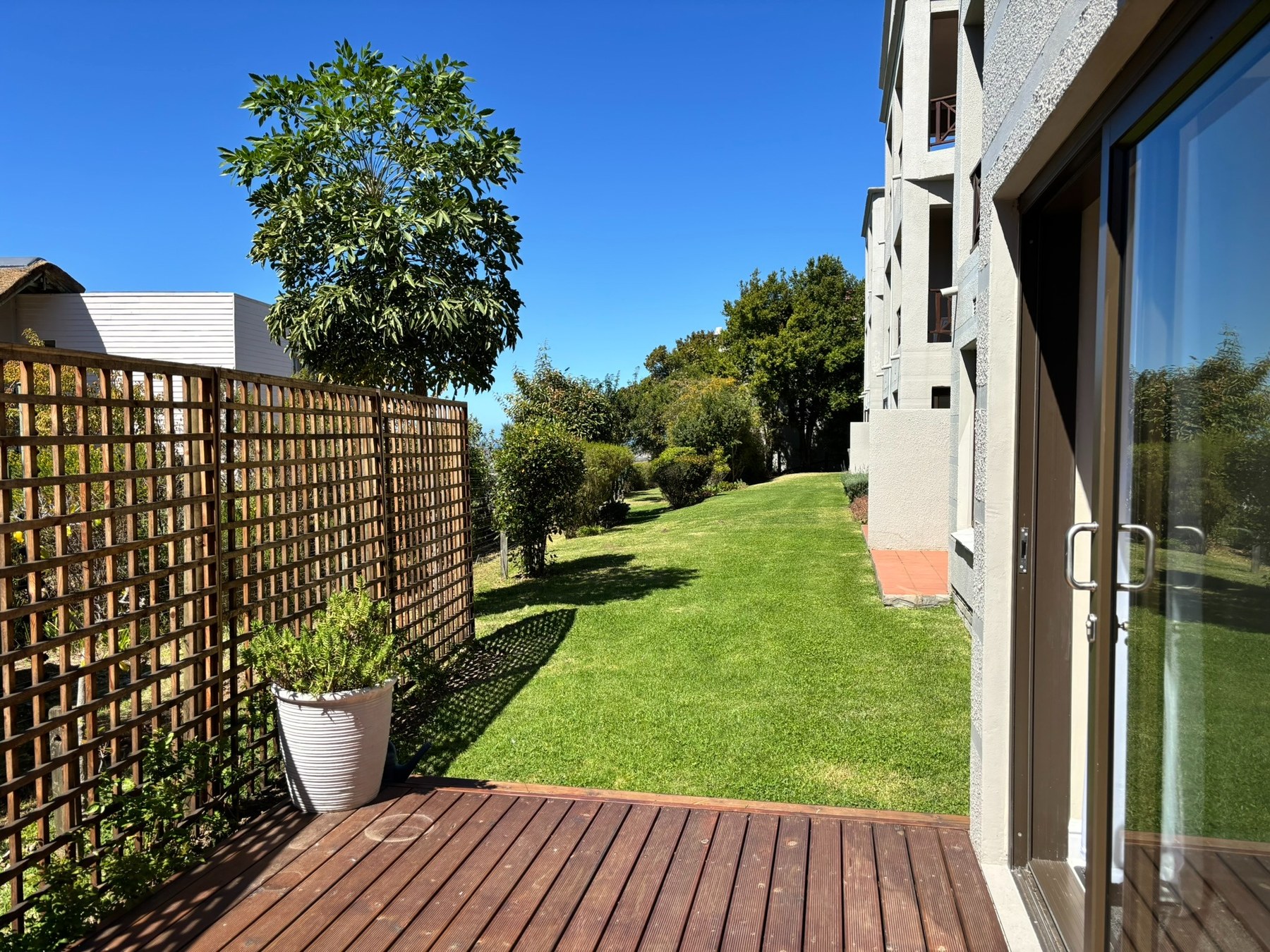 Private wooden patio opening onto the estate gardens
